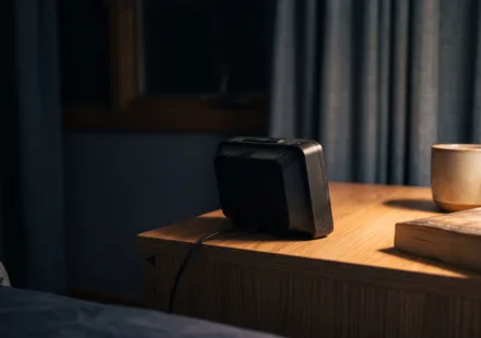 An empty bed at night with the covers pushed back on one side